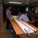You'd think I'd have learned my lesson with the headsail, but no.  Spring of 2015, I decided to try my hand with a mainsail.  This I did in my mom's basement, which is decently big and completely uncluttered.  I brought over a few tables and set them up in a row.  The main, being only 10' long at the foot, and with the help of my most understanding wife, made sewing the horizontal panels easy enough.